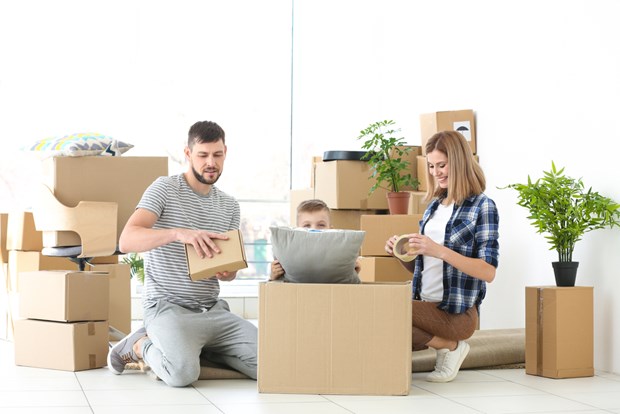 Family unpacking boxes after using Montreal Movers services